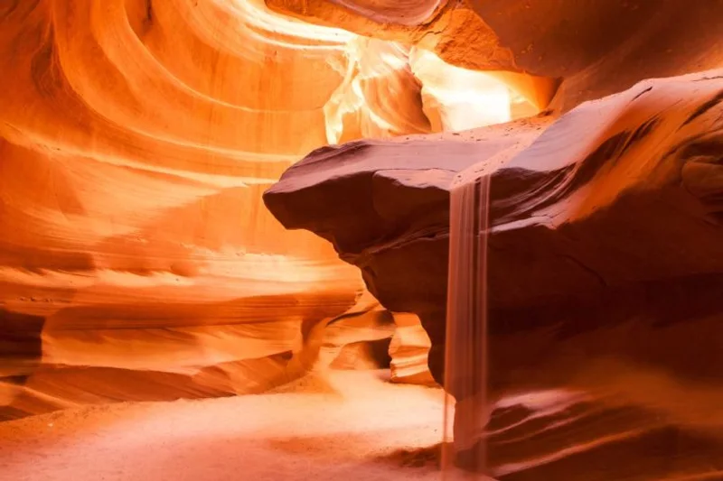 Visitors walking through the glowing orange sandstone corridors of Antelope Canyon