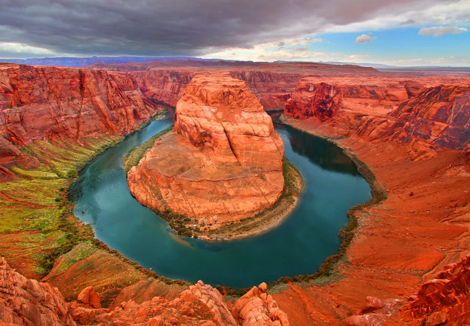 Colorado River from the Horseshoe Bend overlook — emerald green water curving through red sandstone canyon