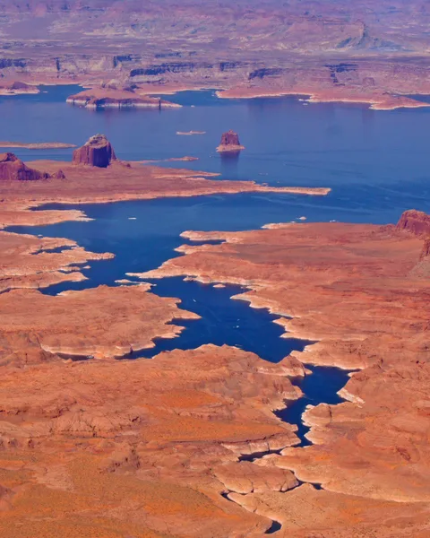 Aerial view of Lake Powell blue water amid red rock desert