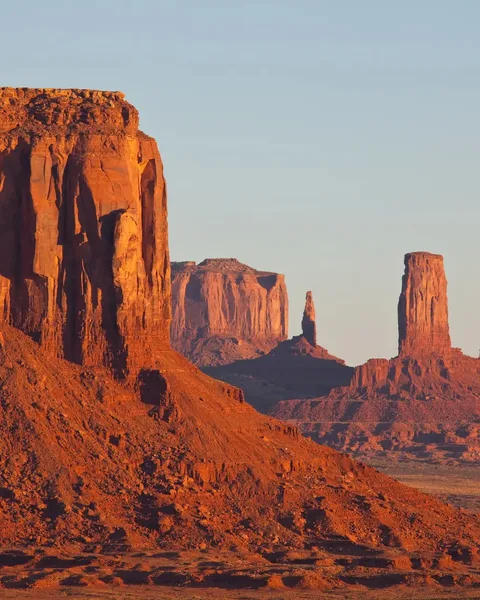 Monument Valley Mittens buttes at sunset with fiery orange sky